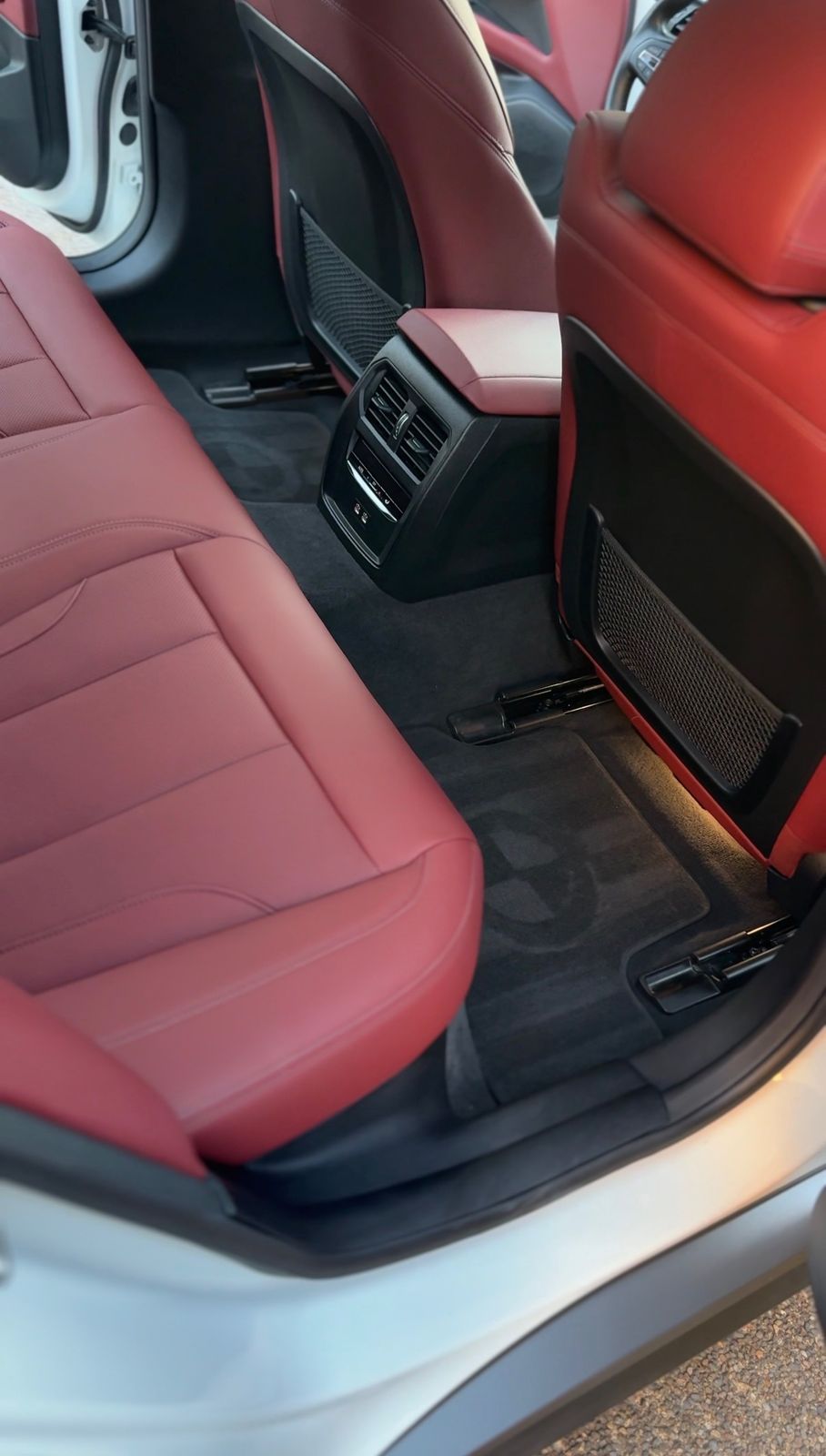BMW red leather rear seats and spotless black carpet